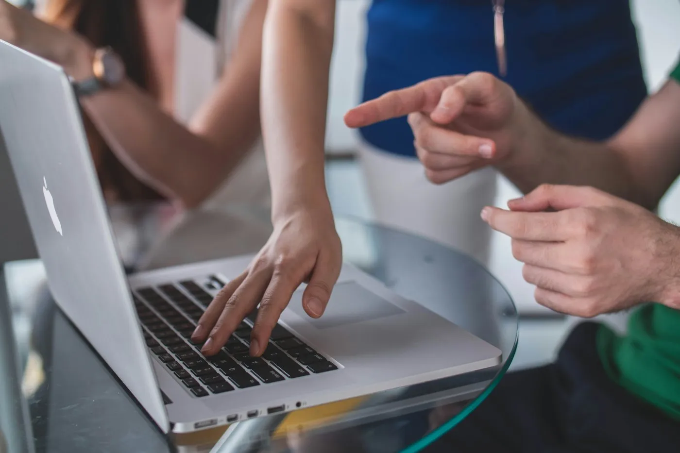 Colleagues pointing at a laptop screen during a review