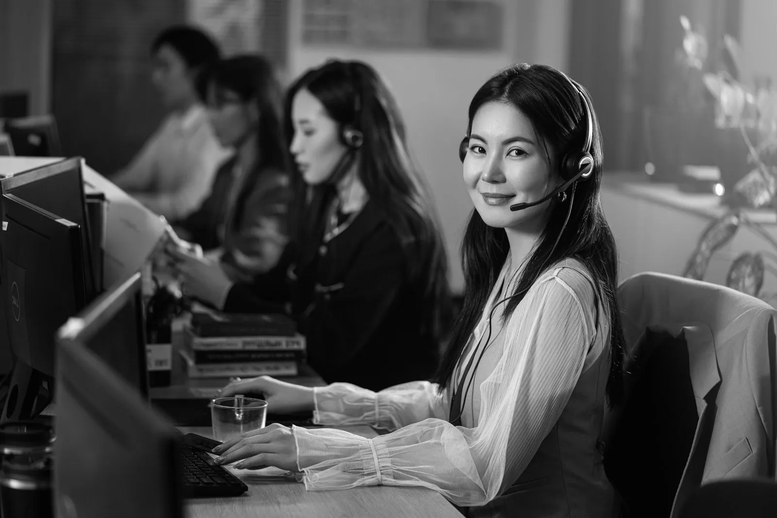 A support agent wearing a headset at her desk